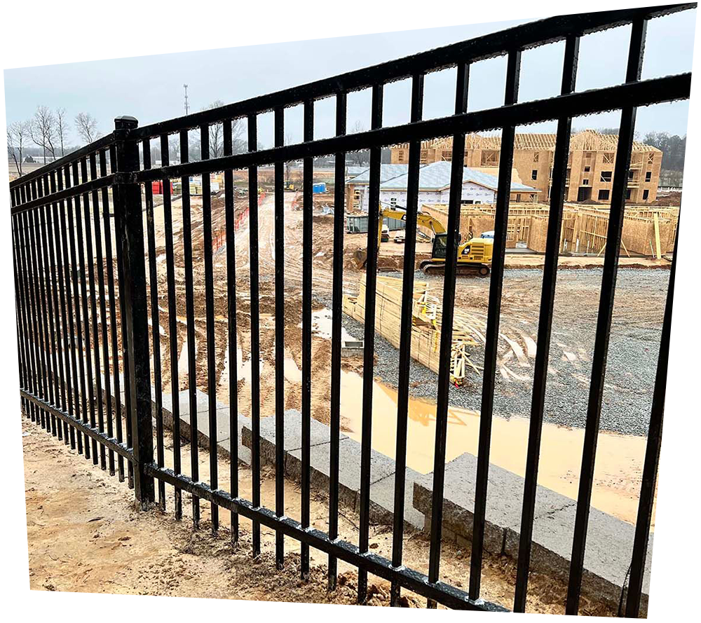 A wooden fence with trees in the background