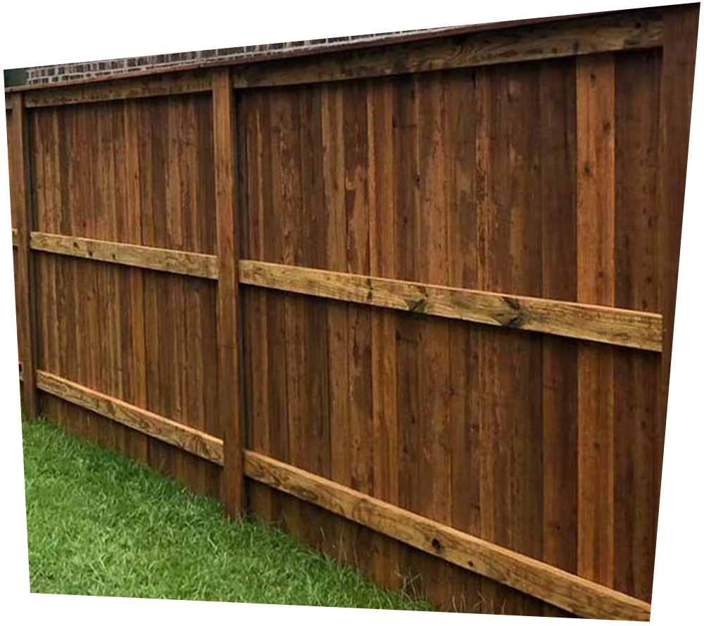 A wooden fence with trees in the background