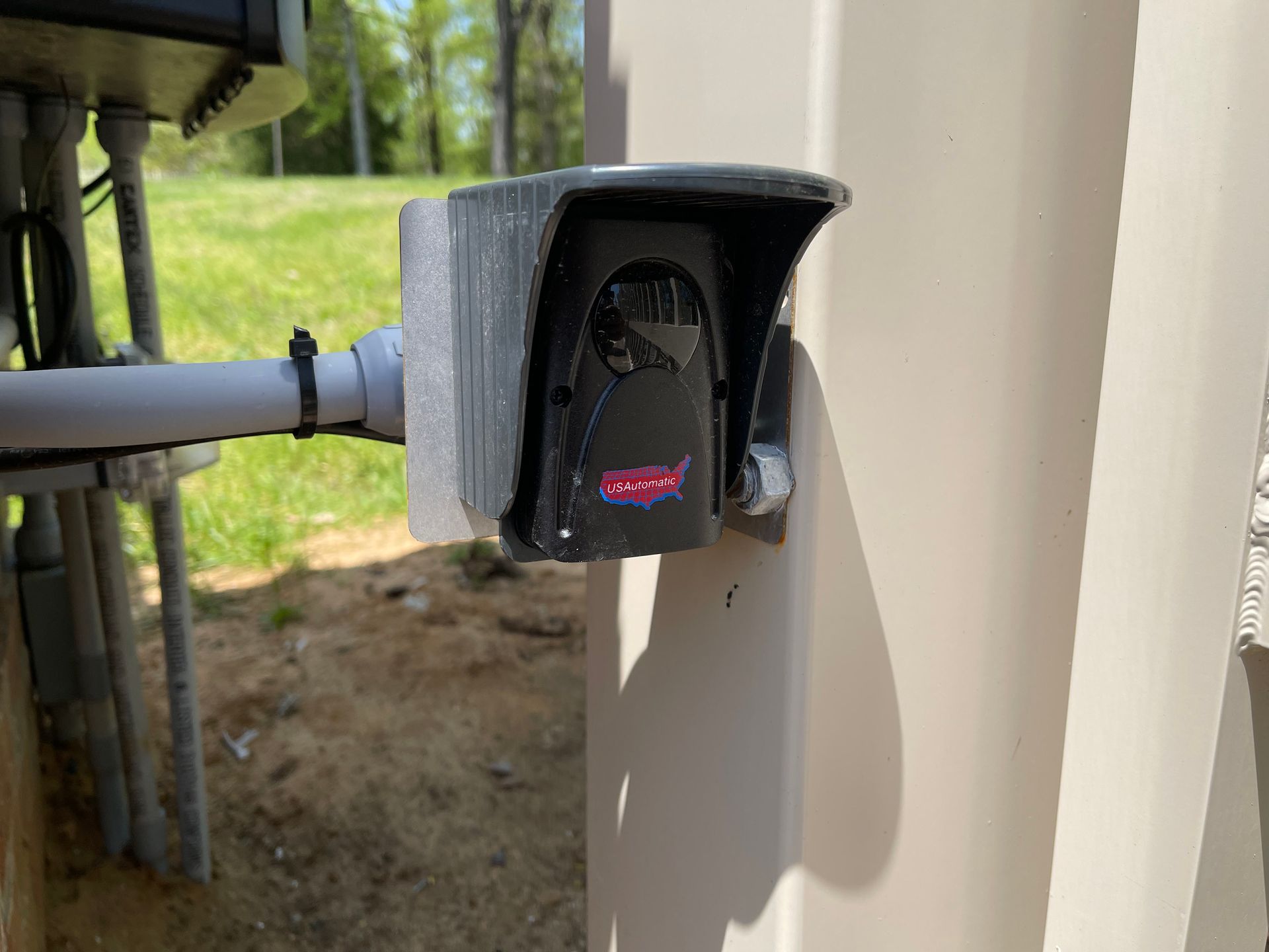 A security camera is mounted on the side of a building.