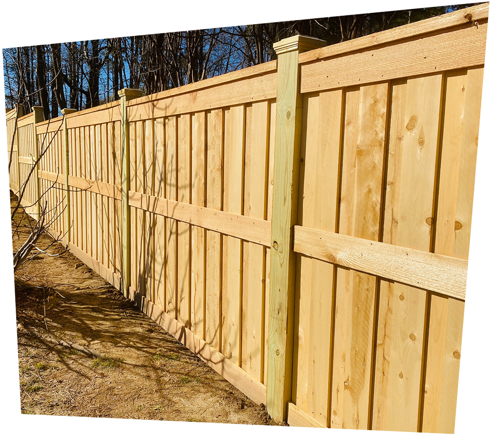 A white vinyl fence with a tree in the background