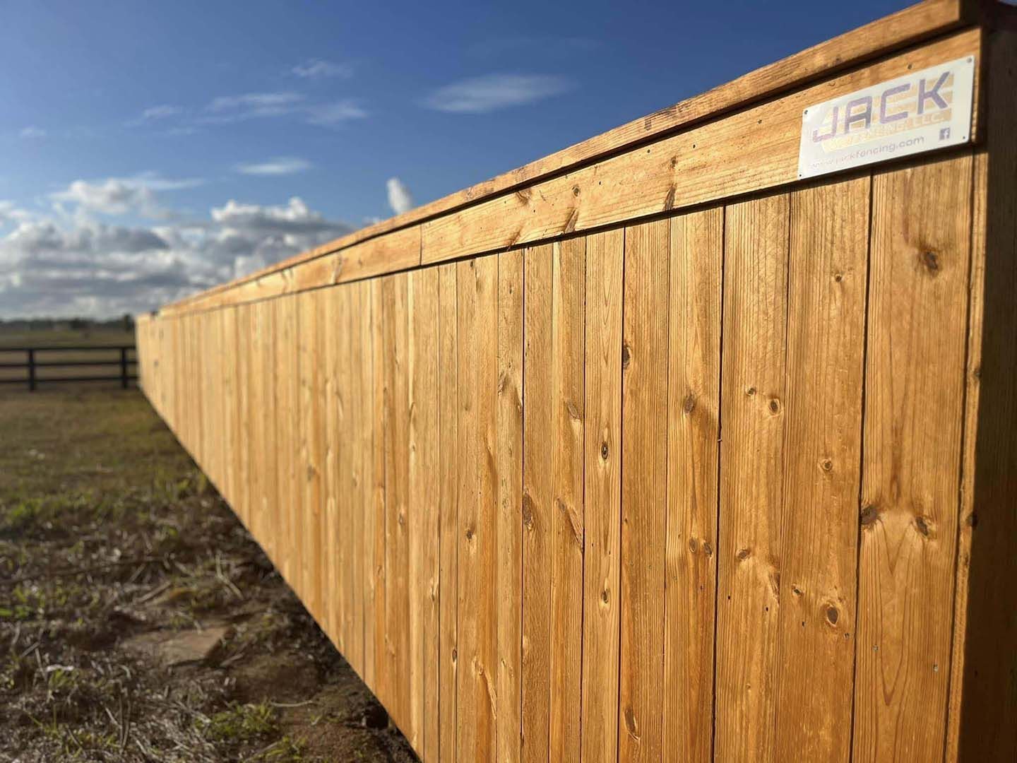 A wooden fence with a sign that says jack on it.