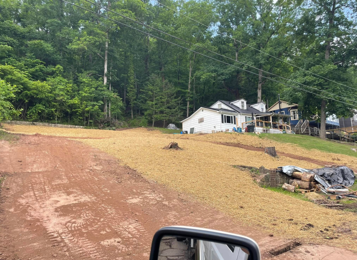 Yellow excavator and orange bulldozer on construction site, moving dirt.