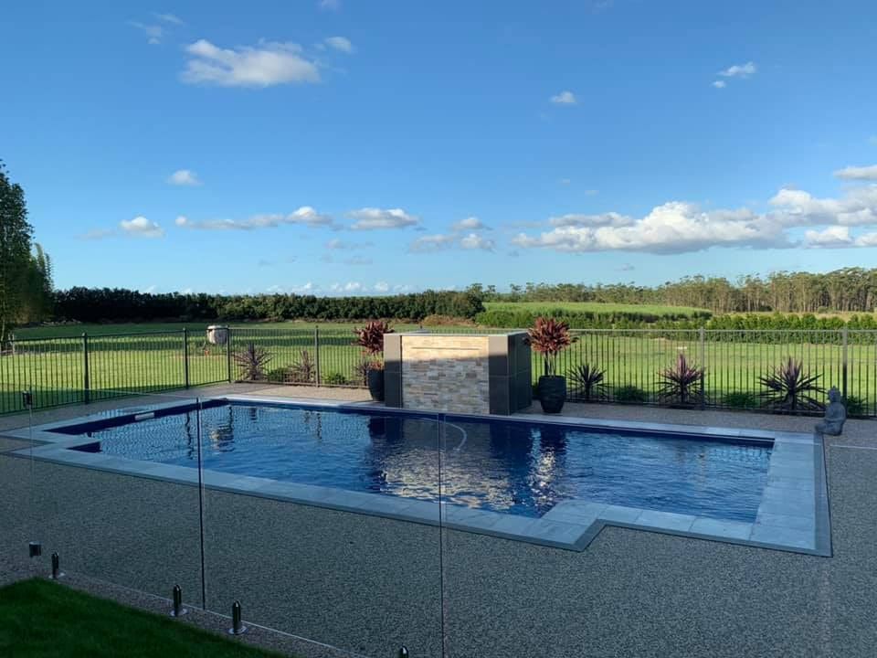 A Swimming Pool Surrounded by a Glass Fence — Aqualine Pools in Branyan, QLD
