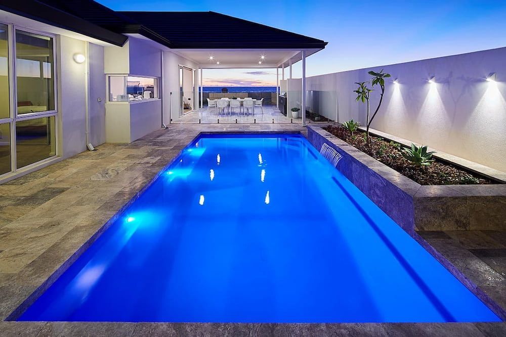 A Large Swimming Pool in the Backyard of a House — Aqualine Pools in Moore Park Beach, QLD