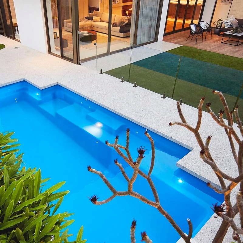 A Large Swimming Pool in the Backyard of a House — Aqualine Pools in Branyan, QLD