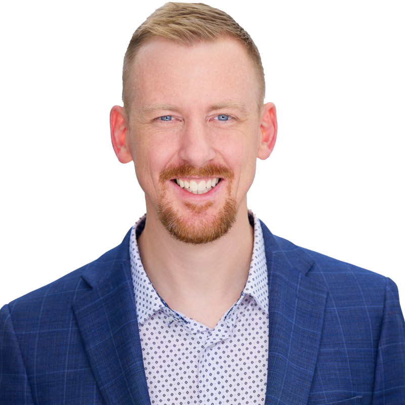 A man in a suit and tie is standing with his arms crossed.