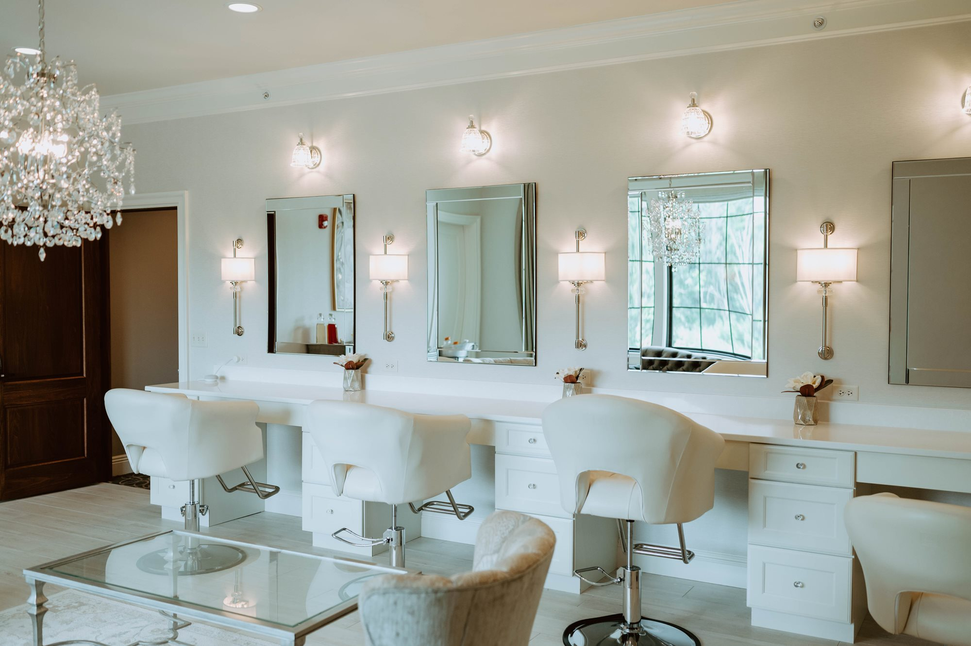 A room with a lot of mirrors and chairs in it.