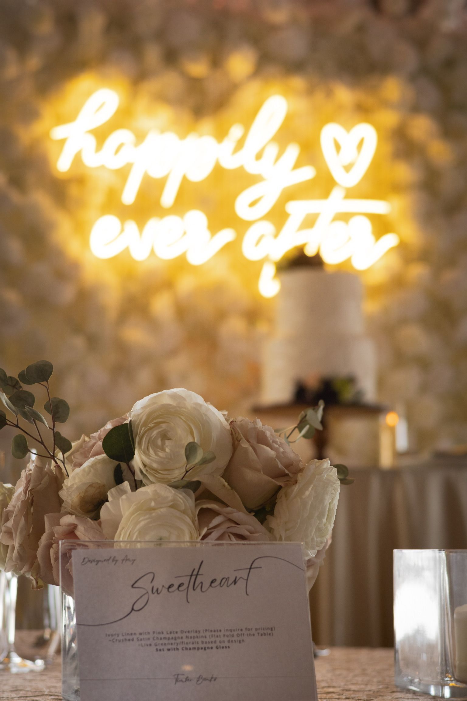 Wedding reception, floral centerpiece in front of 