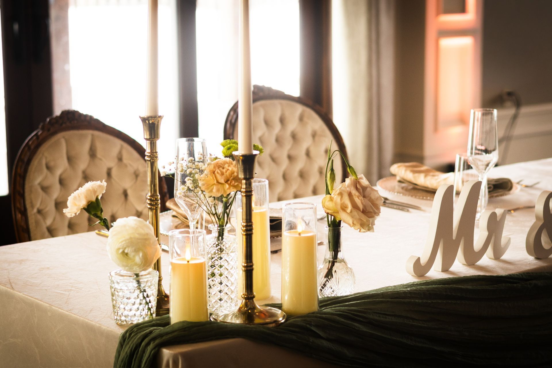 Wedding reception table with candles, flowers, and 