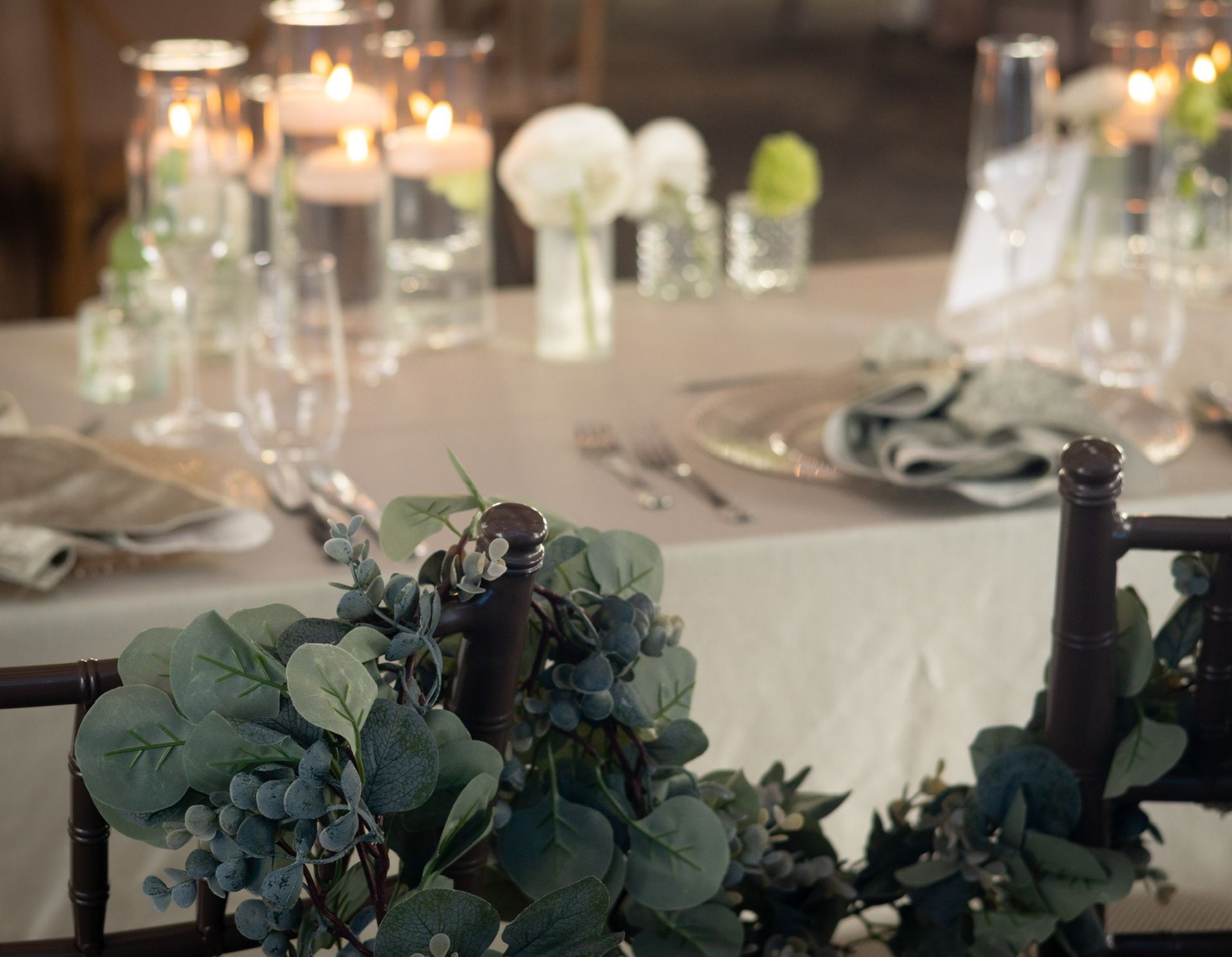 Table setting with greenery accents and candles.