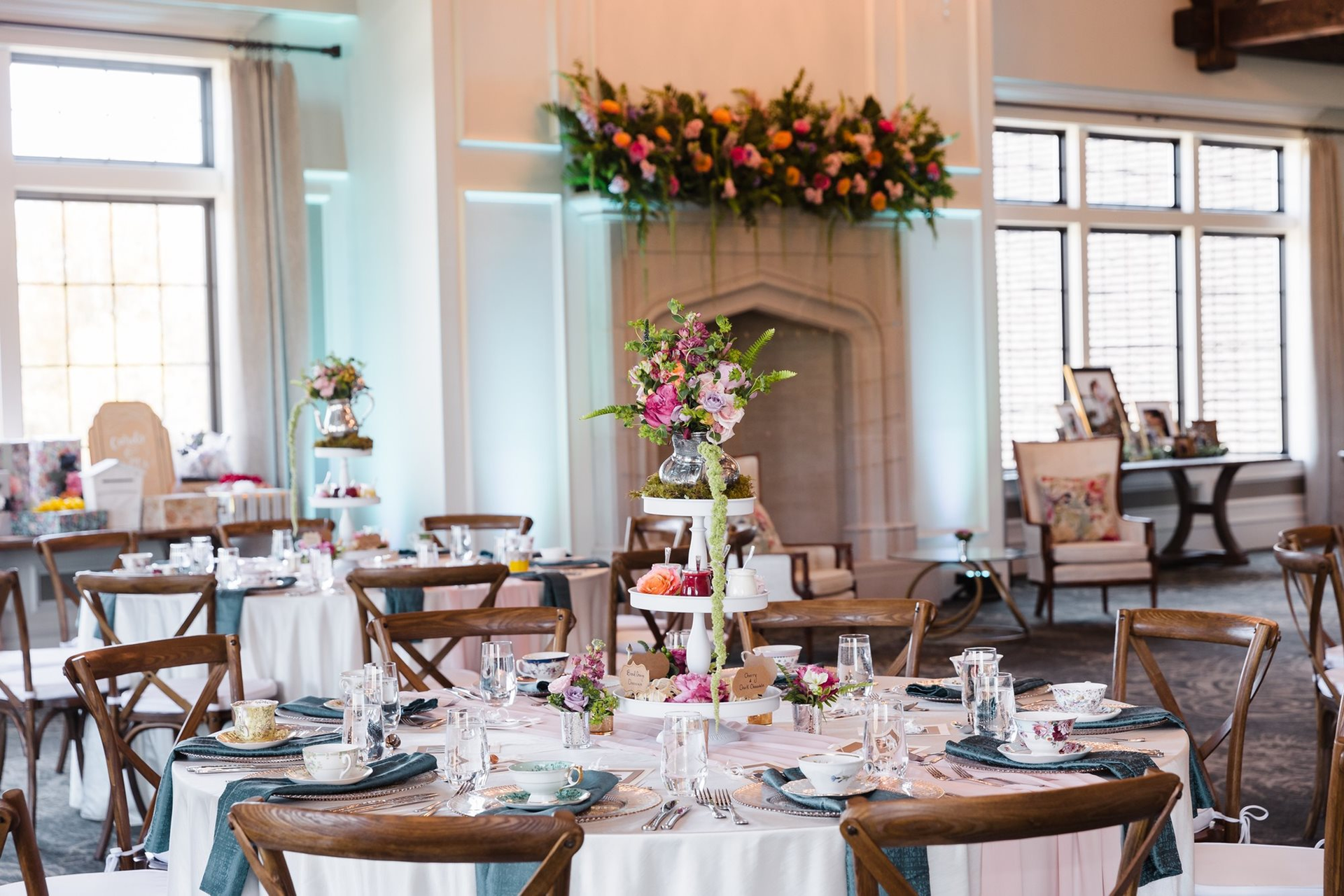 A room with tables and chairs set up for a wedding reception.