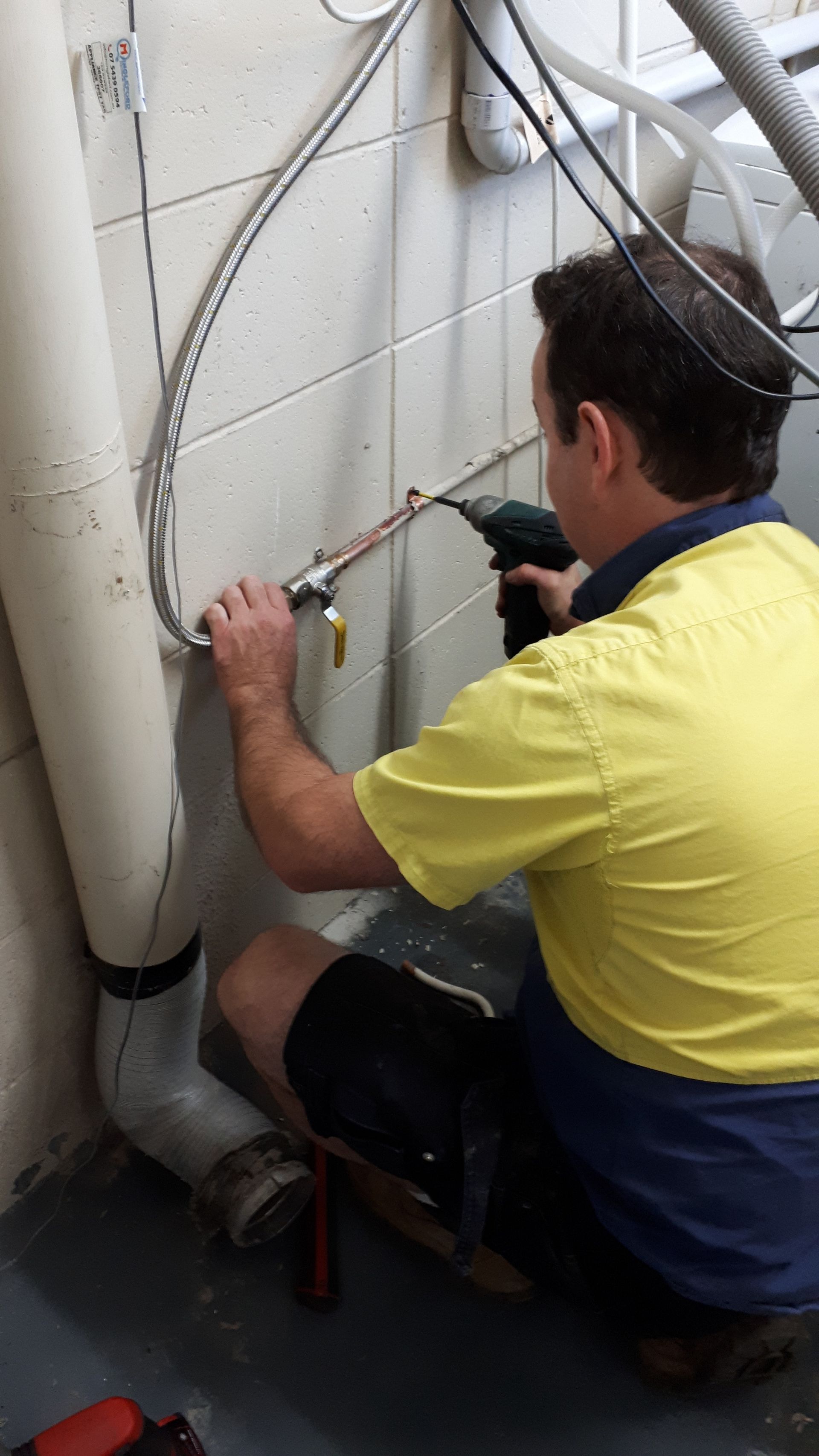 Man Repairing Fridge With Customer — Mingleford Electrical Airconditioning Solar & Gas In Landsborough, QLD