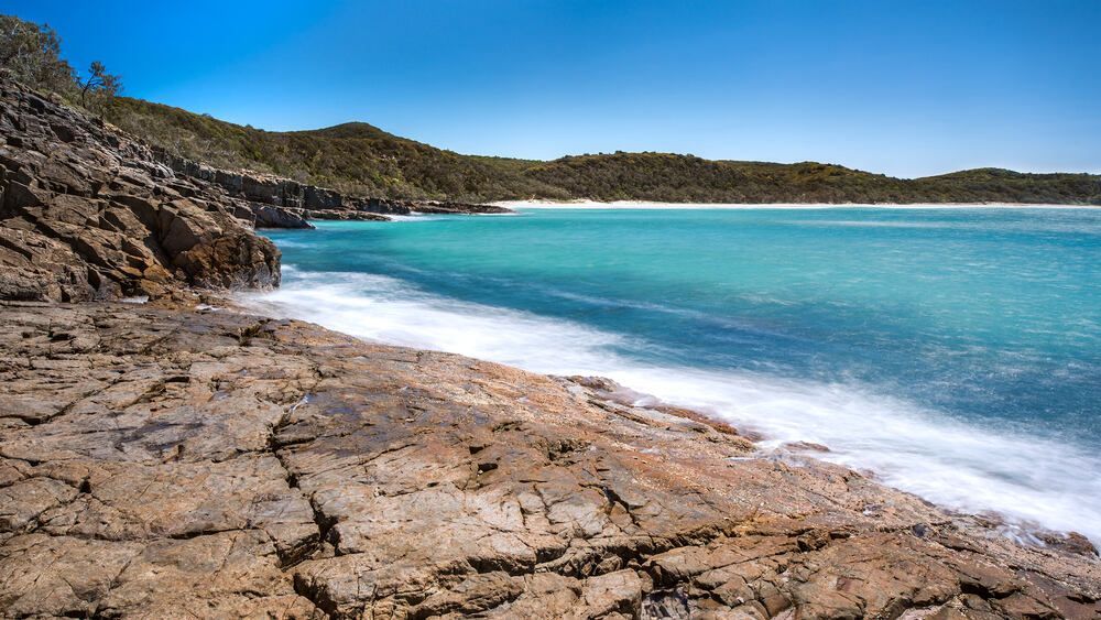 Rocky Beach Next To A Large Body Of Water — Mingleford Electrical Airconditioning Solar & Gas In Elimbah, QLD