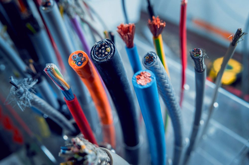 Bunch Of Different Colored Electrical Wires Are Sitting On A Table — Mingleford Electrical Airconditioning Solar & Gas In Maleny, QLD