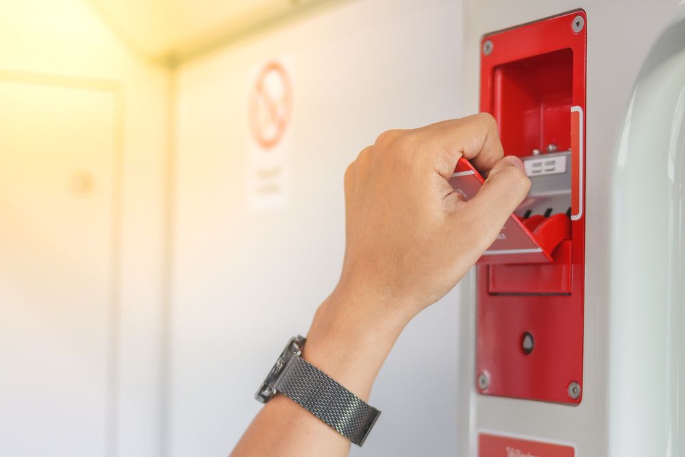 Person Holding A Red Electrical Object In Their Hand — Mingleford Electrical Airconditioning Solar & Gas In Landsborough, QLD