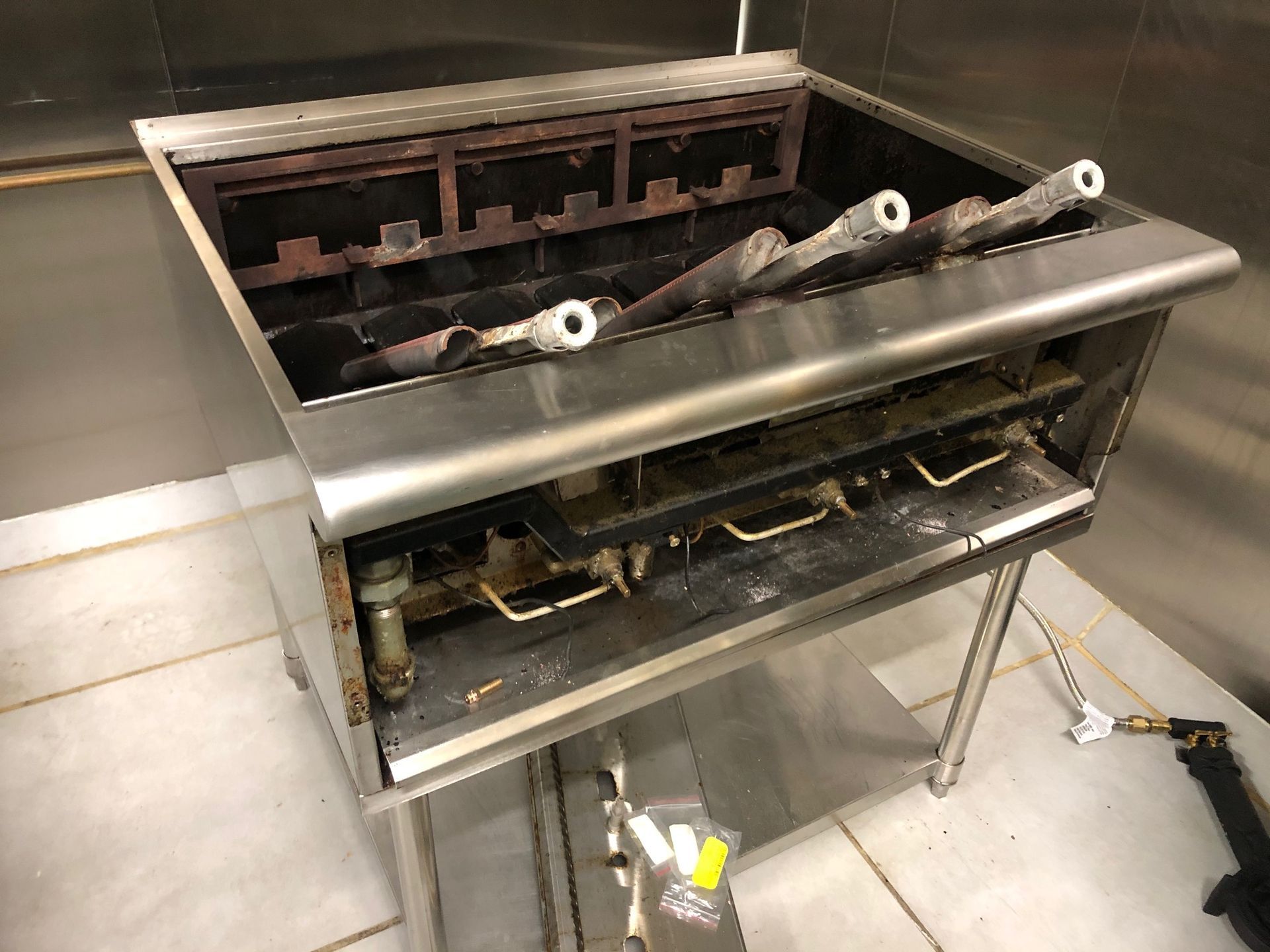 Worker Repairing Microwave Oven In Kitchen — Electrical Services In Landsborough, QLD