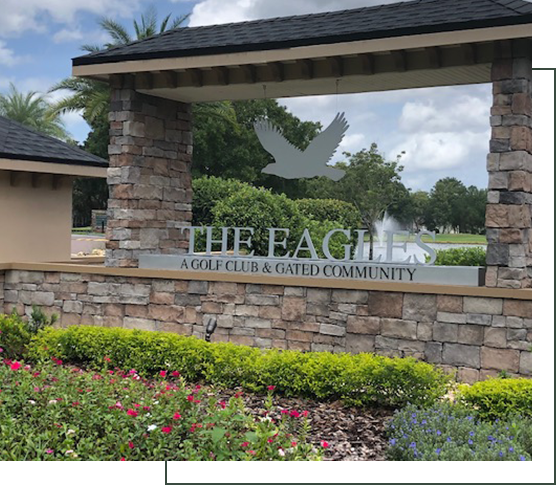 A sign for the eagle golf club and gated community