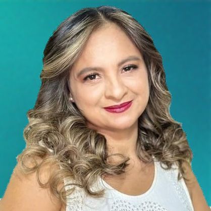 Woman with wavy brown hair, smiling, wearing a white top, and a dark lipstick.