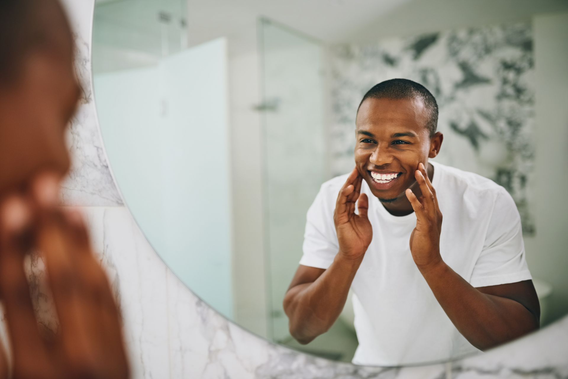 Man looking at smile in mirror