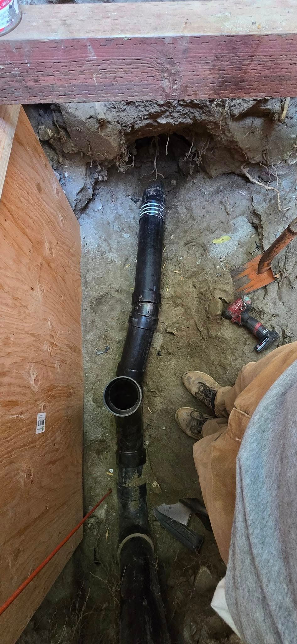 A pipe is being installed in a hole in the ground.