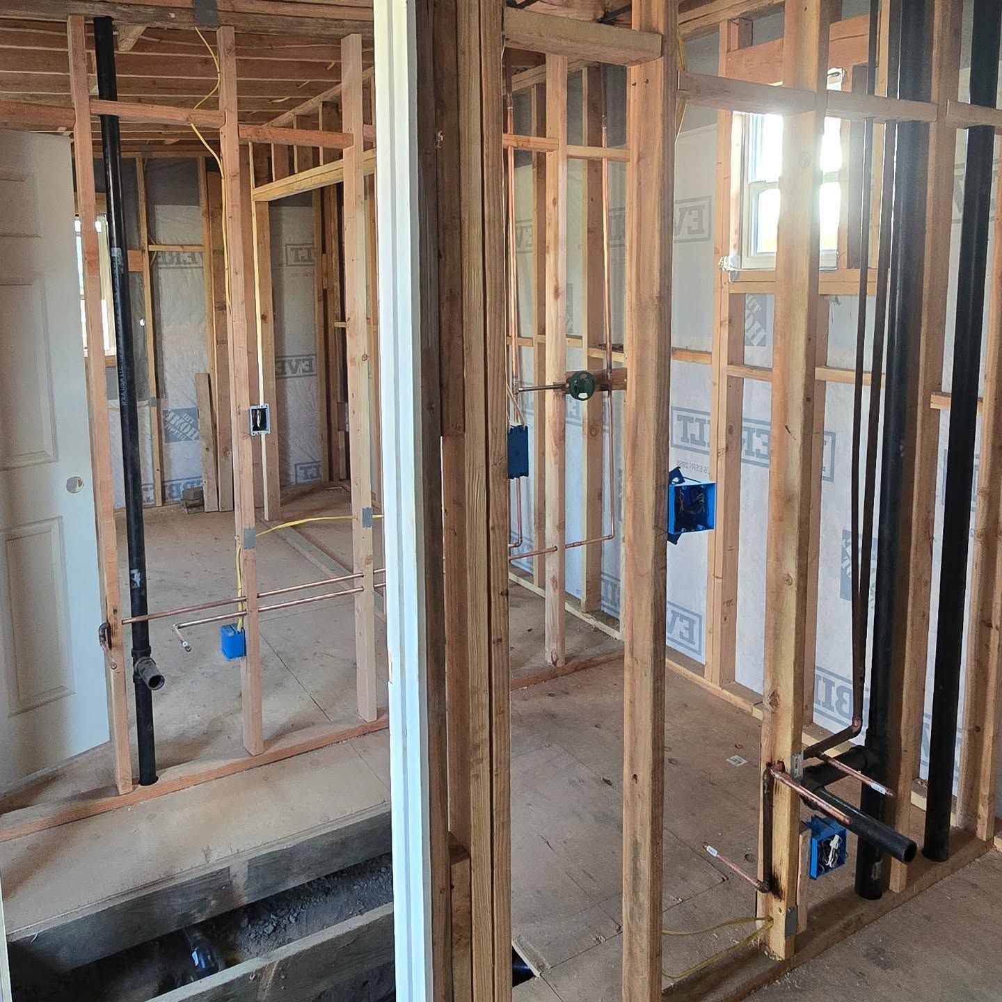 A room with a lot of wooden frames and pipes in it.