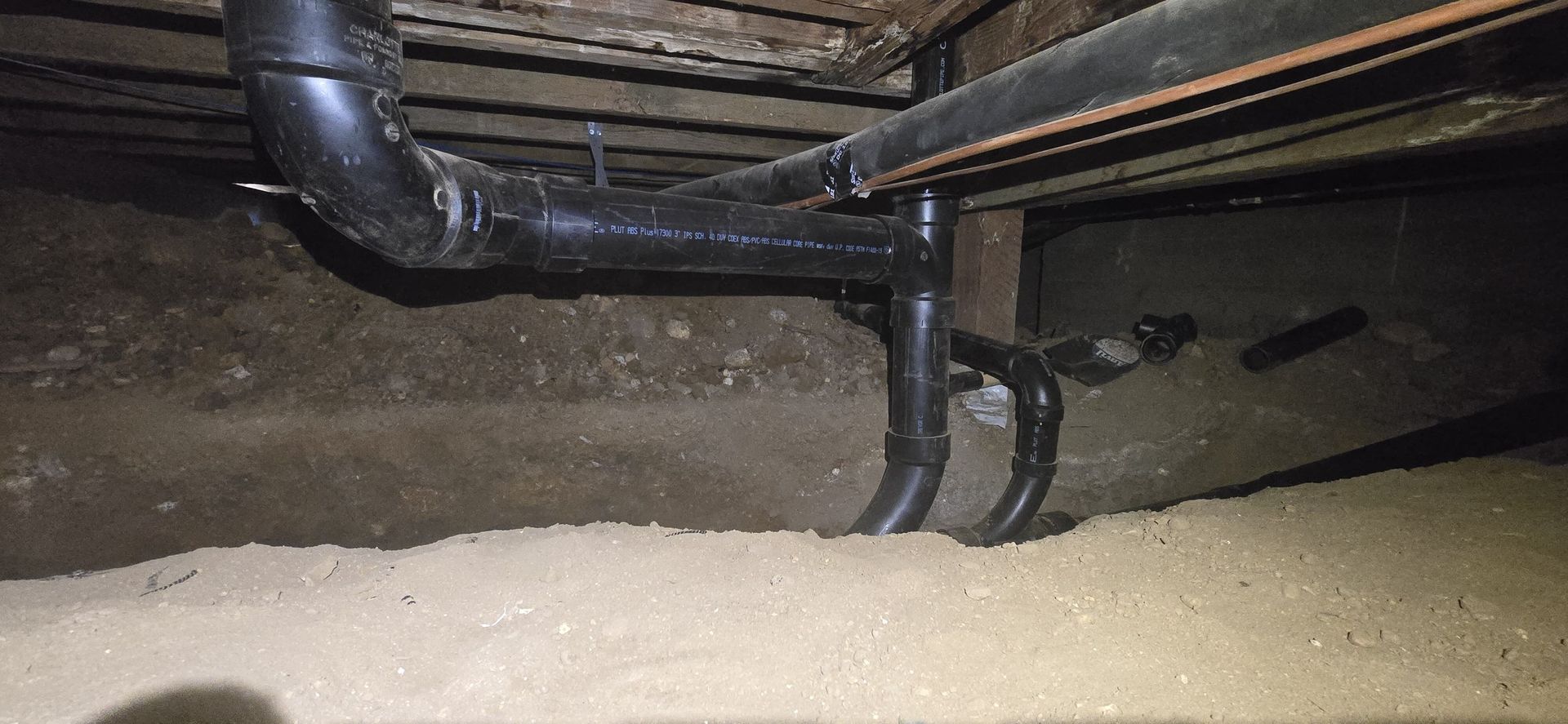 A close up of a pipe in a basement.