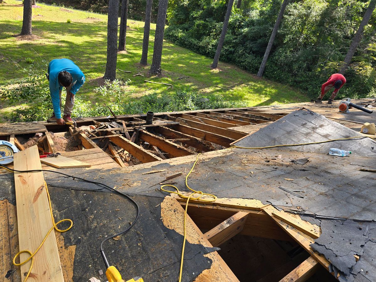 A man is working on the roof of a house.