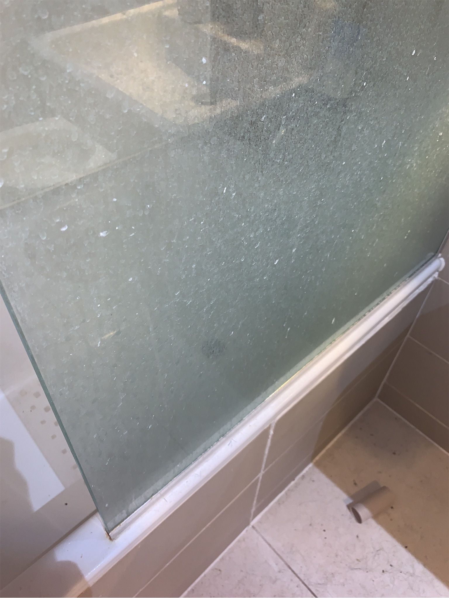 Shower screen with heavy limescale and soap residue – end of tenancy condition