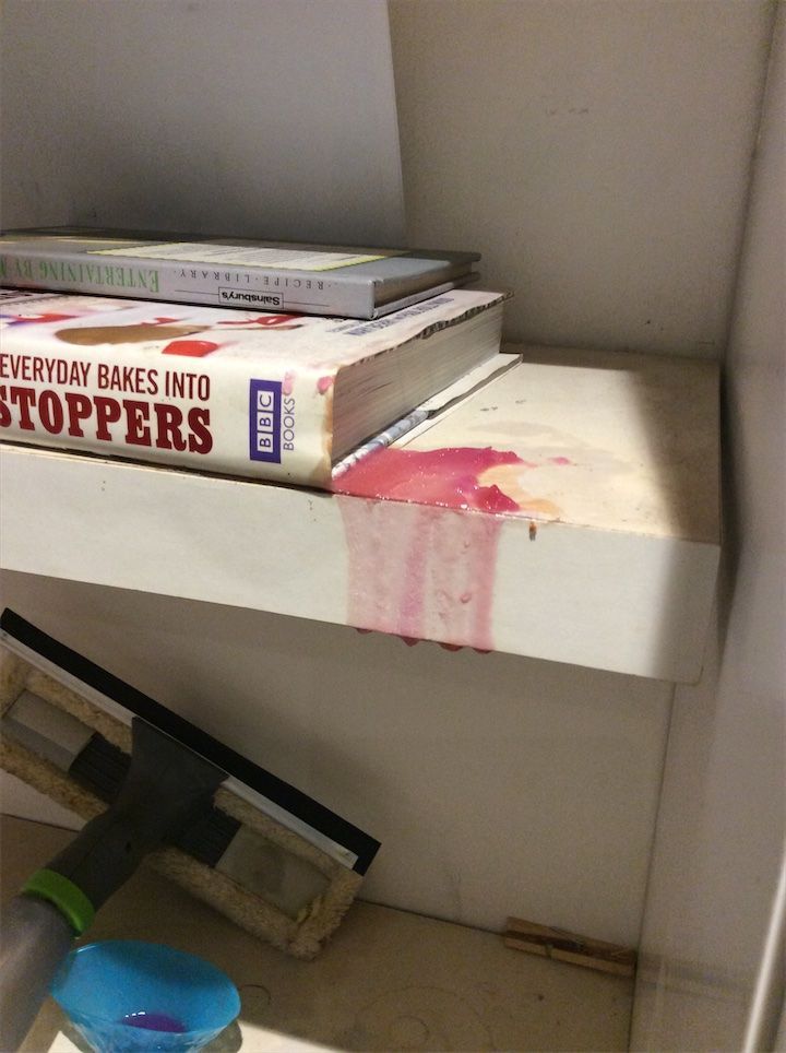 White shelf with pink wax residue and surface staining – check-out condition