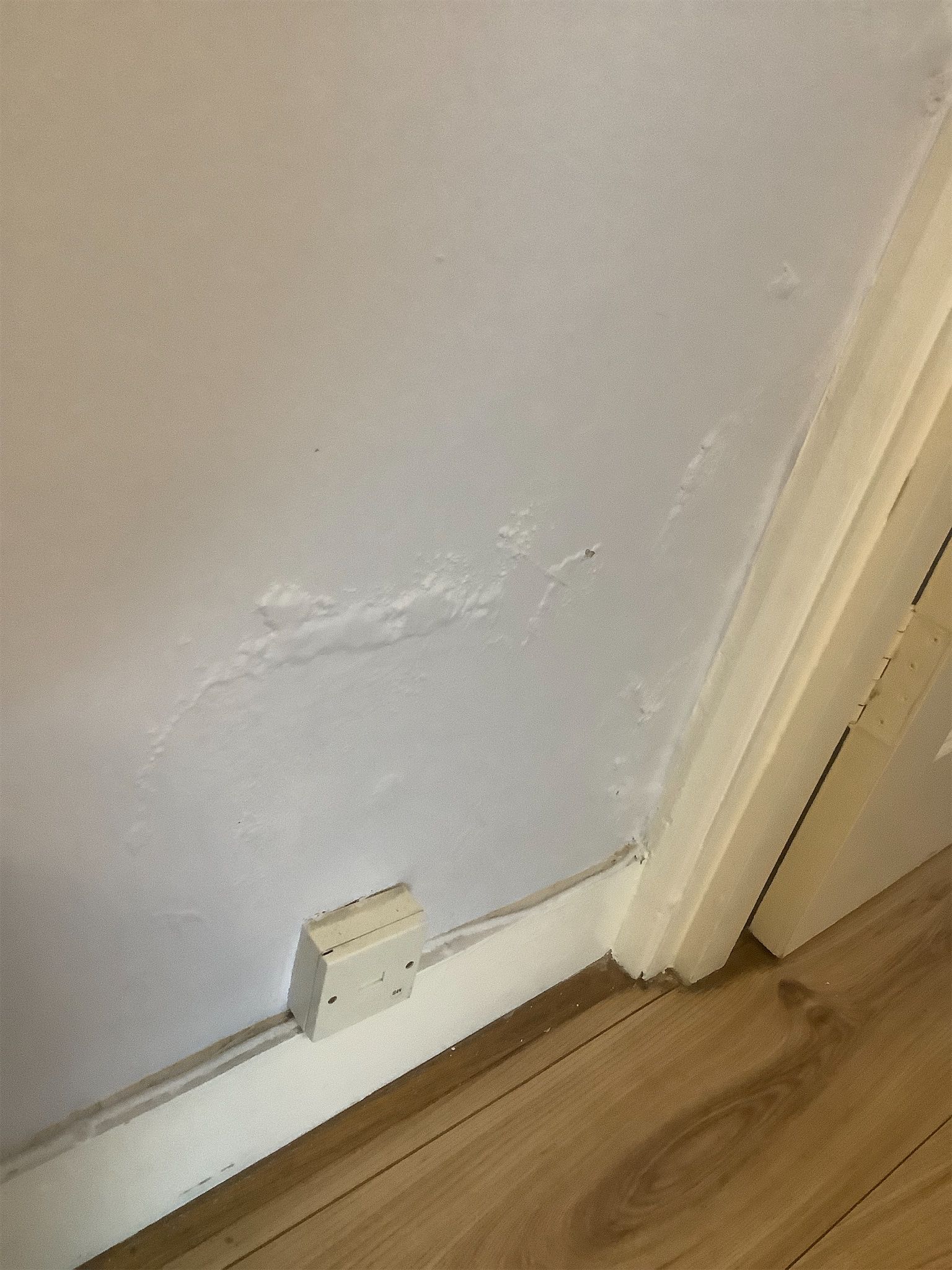 Raised and blistered bedroom wall paintwork consistent with moisture