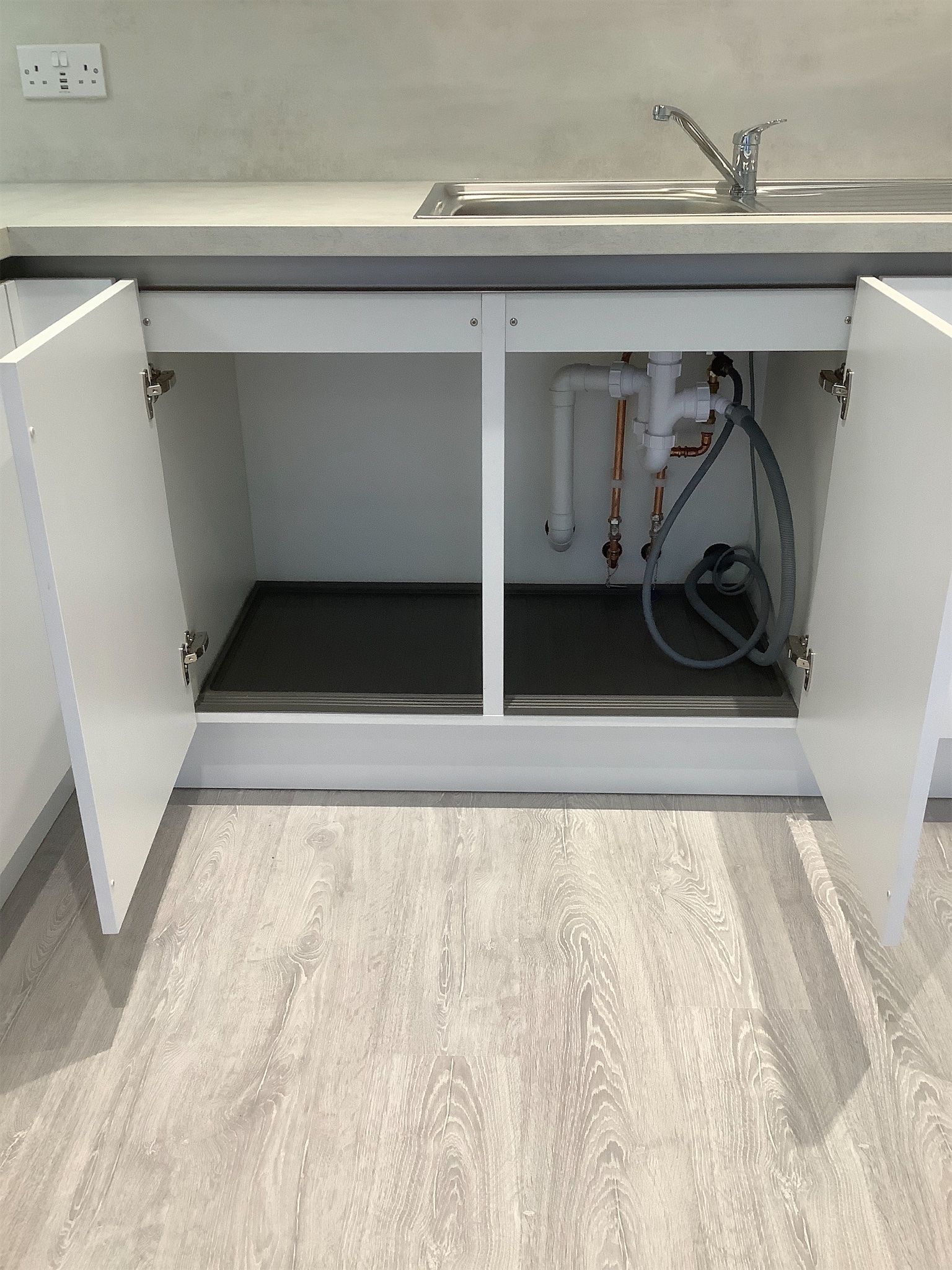 Storage cupboard below kitchen sink – condition documented