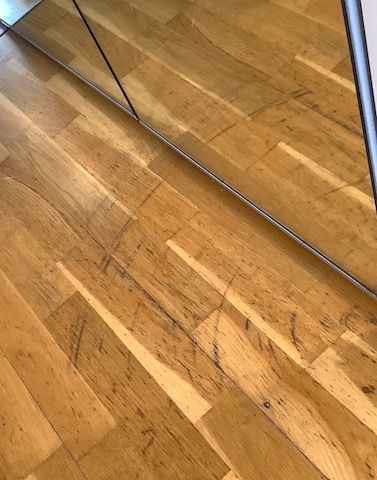 Photo of damaged floor for check-in report which will prevent dispute at check-out