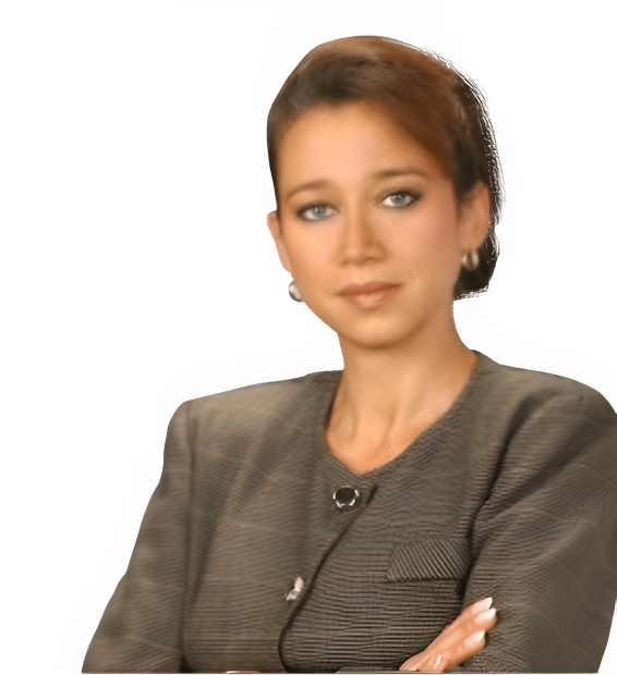 A woman in a suit with her arms crossed looks at the camera