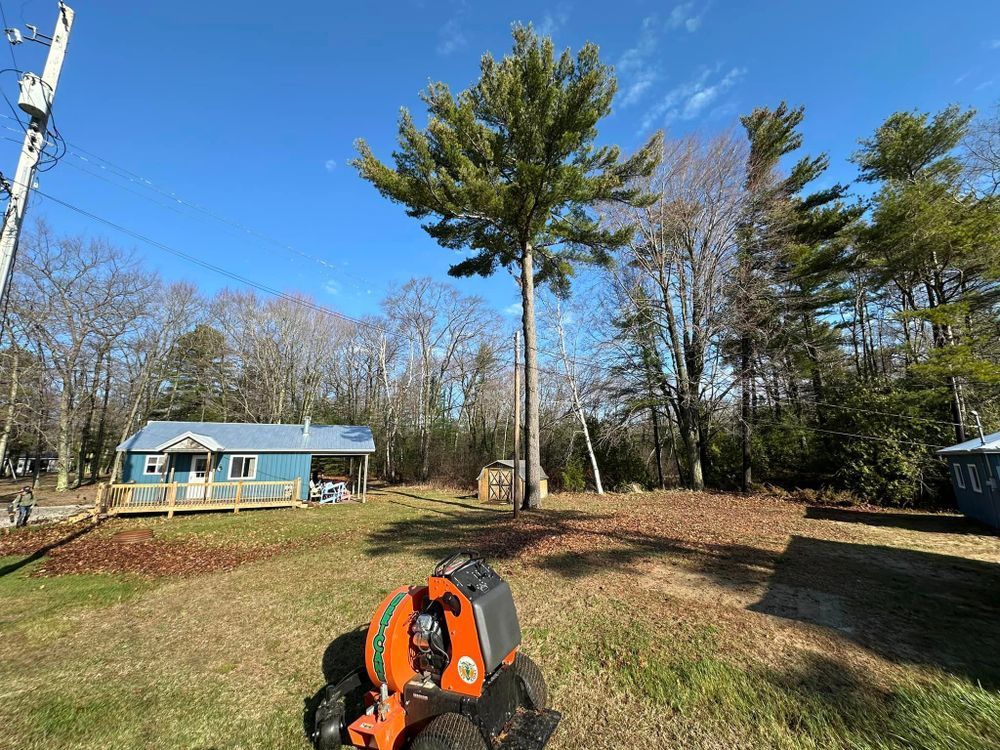 A tree stump grinder is sitting in front of a house.