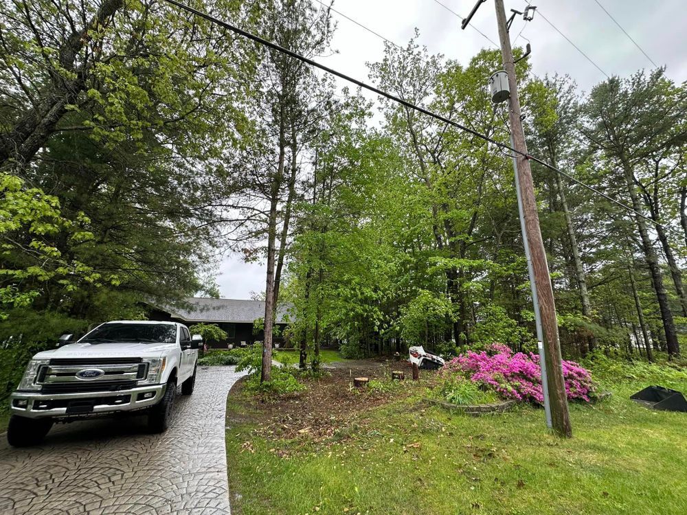A white truck is parked in a driveway next to a house.
