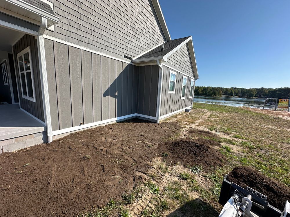 A house with a lot of dirt in front of it.