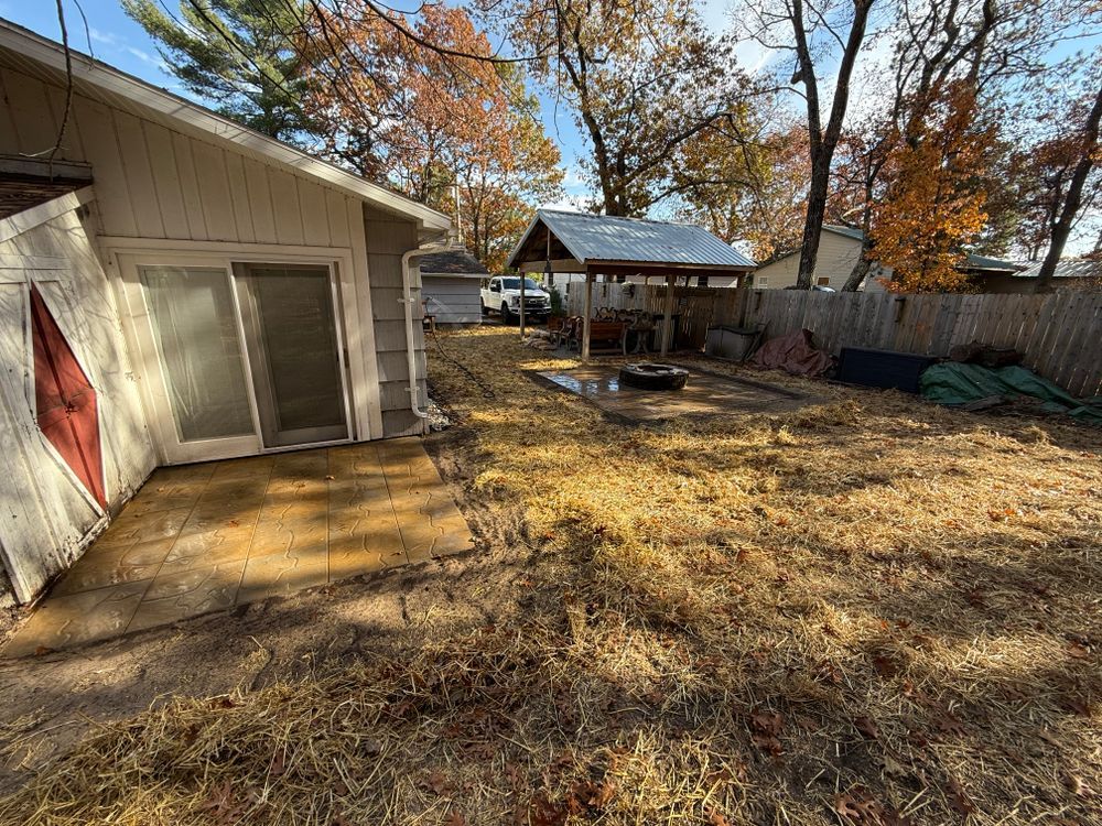 There is a shed in the backyard of a house.