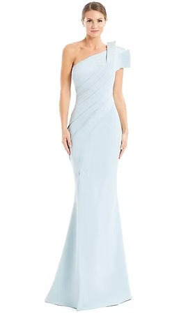Woman in a light blue one-shoulder gown with ruffled shoulder detail, standing against a white background.