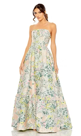 Woman in strapless floral gown. Pale pink, green, and yellow pattern. Full-length, posing in a studio.