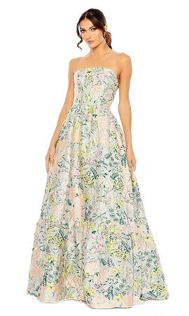 Woman in strapless floral gown. Pale pink, green, and yellow pattern. Full-length, posing in a studio.
