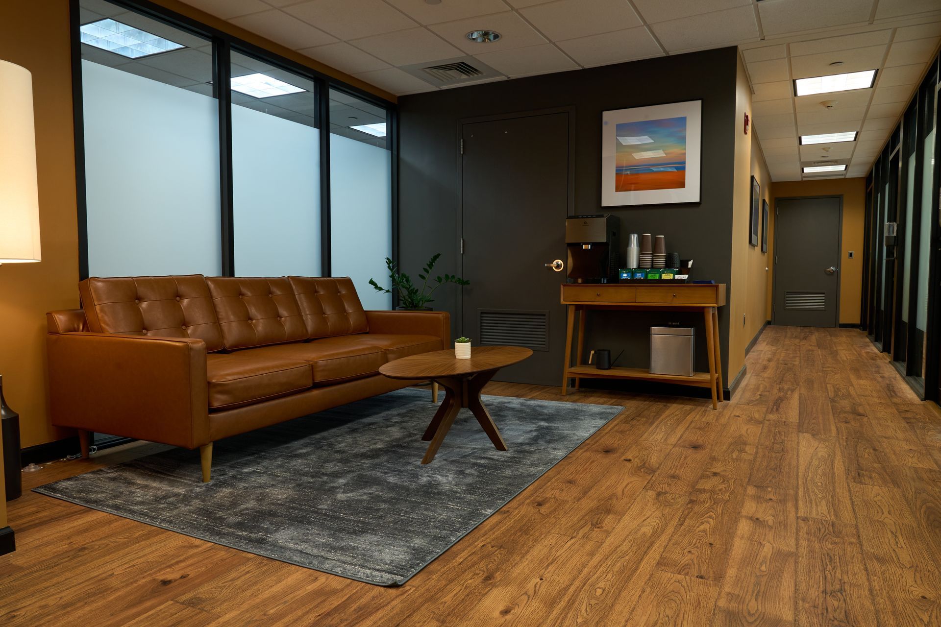 A living room with a couch , table , and rug.