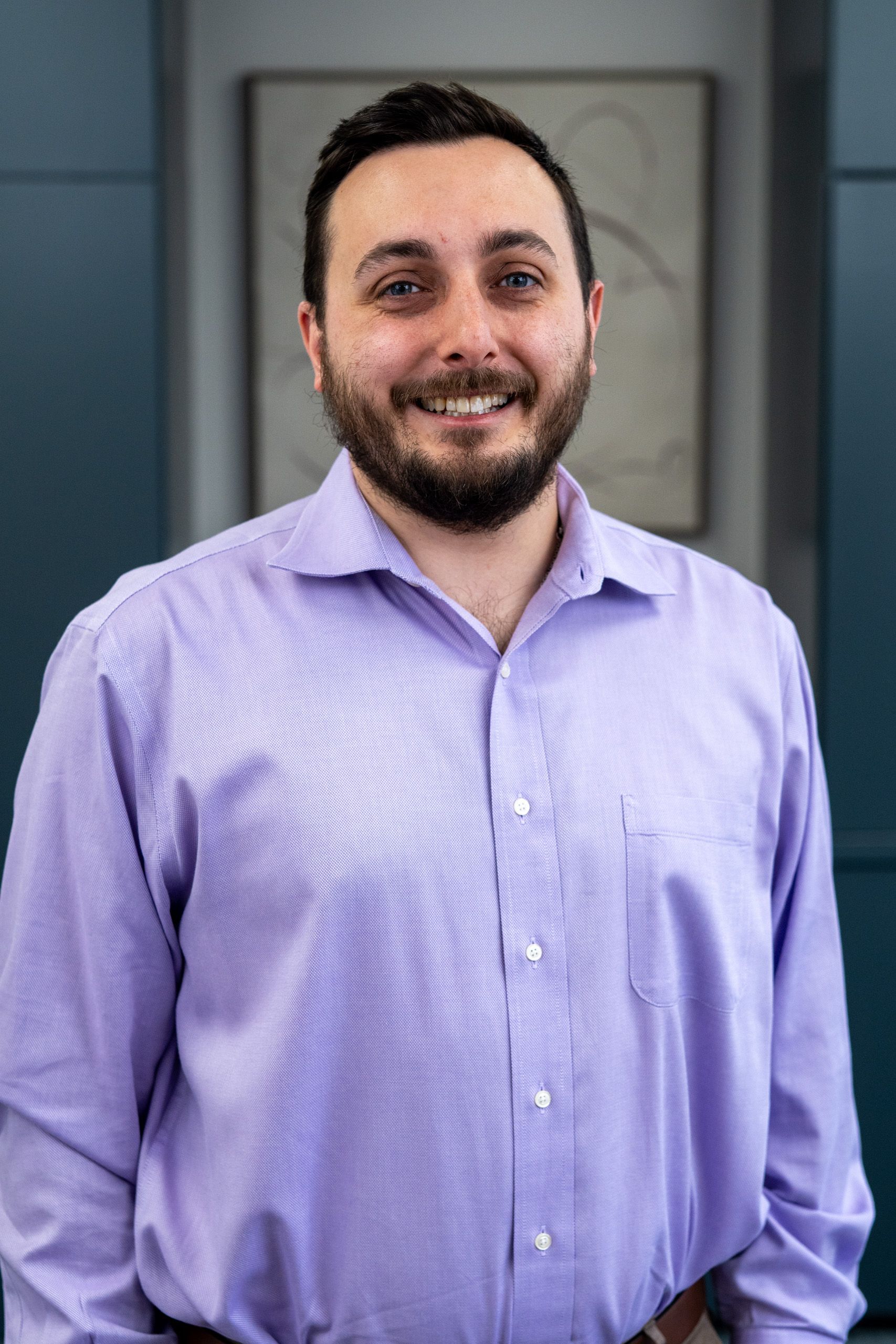 A man stands in front of a sign that says evolve brain