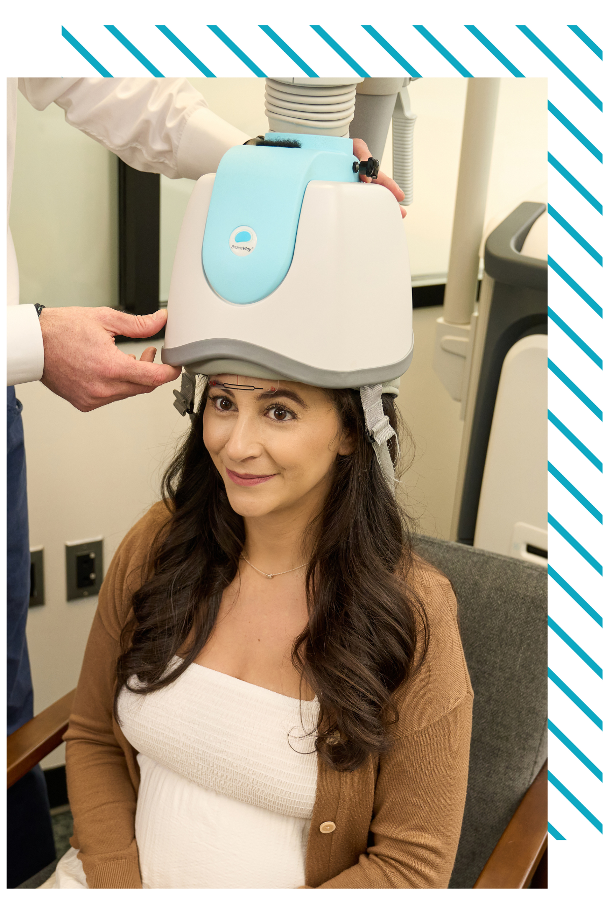 A woman is sitting in a chair with a helmet on her head.