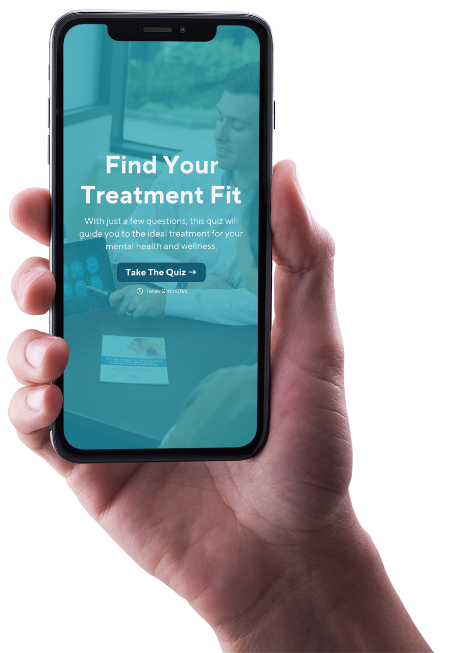 A hand is holding a cell phone that says find your treatment fit on the screen.