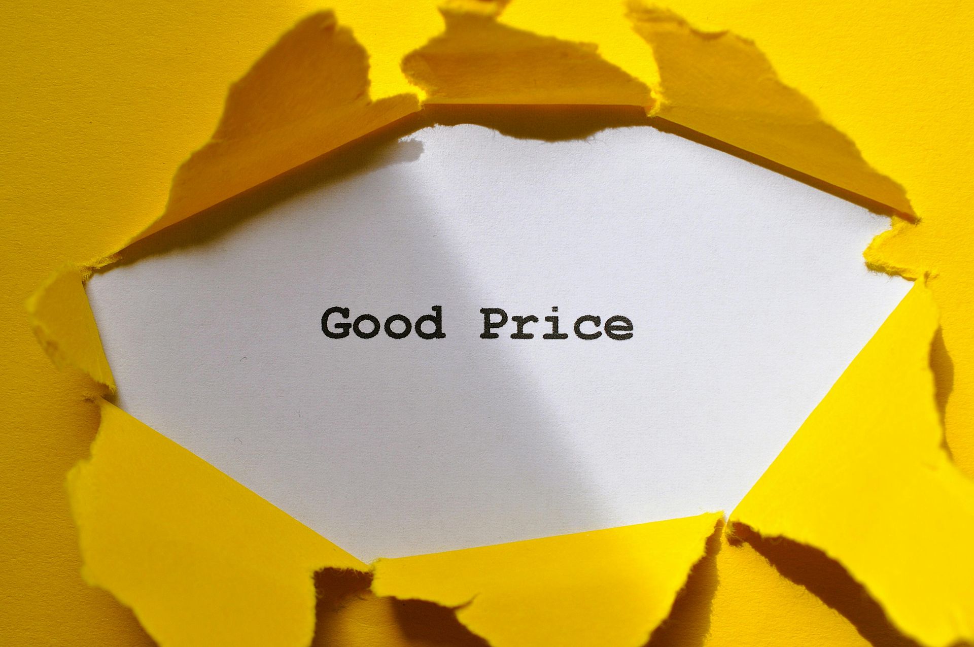 Torn yellow paper revealing white center with “Good Price” text