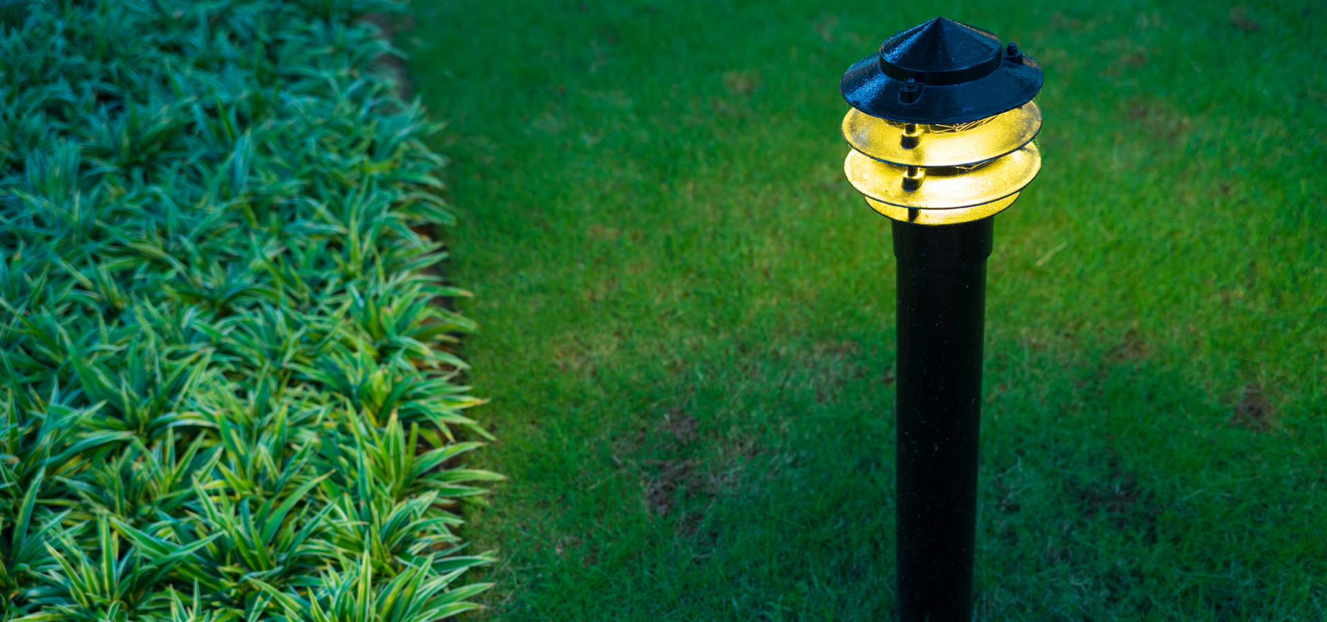 Bollard light in a garden landscaped by Louisville Landscape Pros