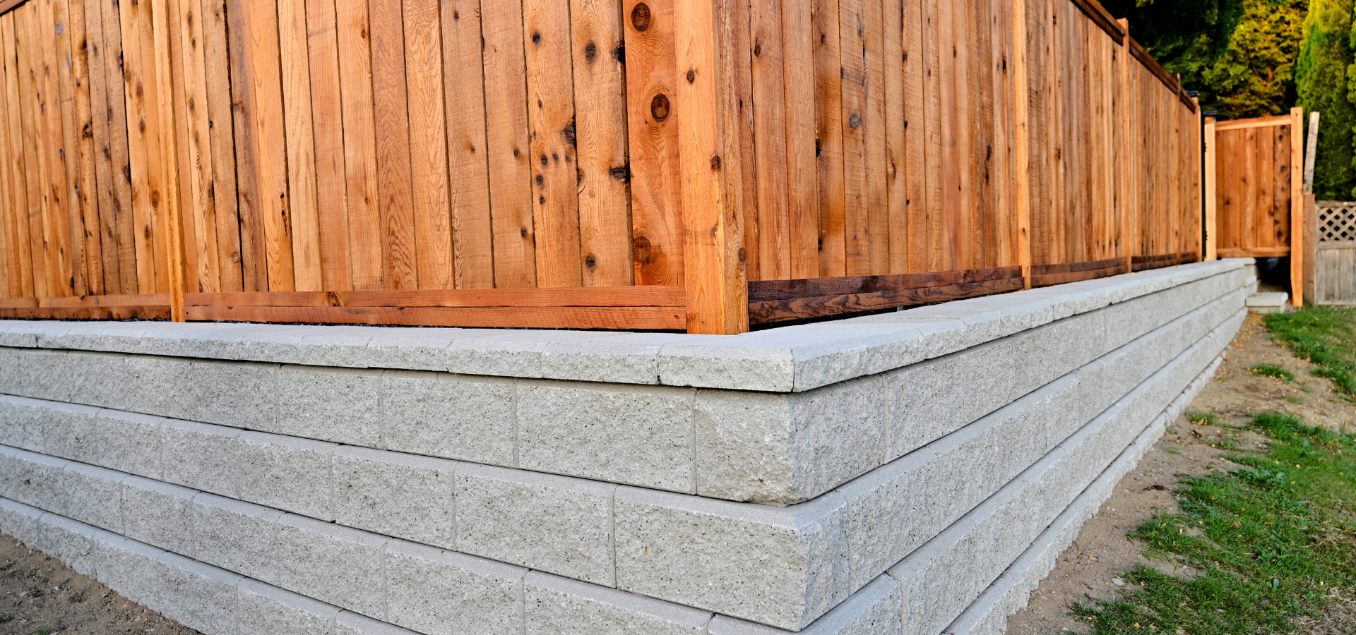 A simple but elegant design of wooden fences on top of retaining walls