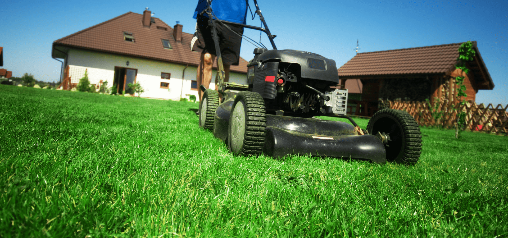 Homeowner in Louisville, KY, mowing her lawn in spring