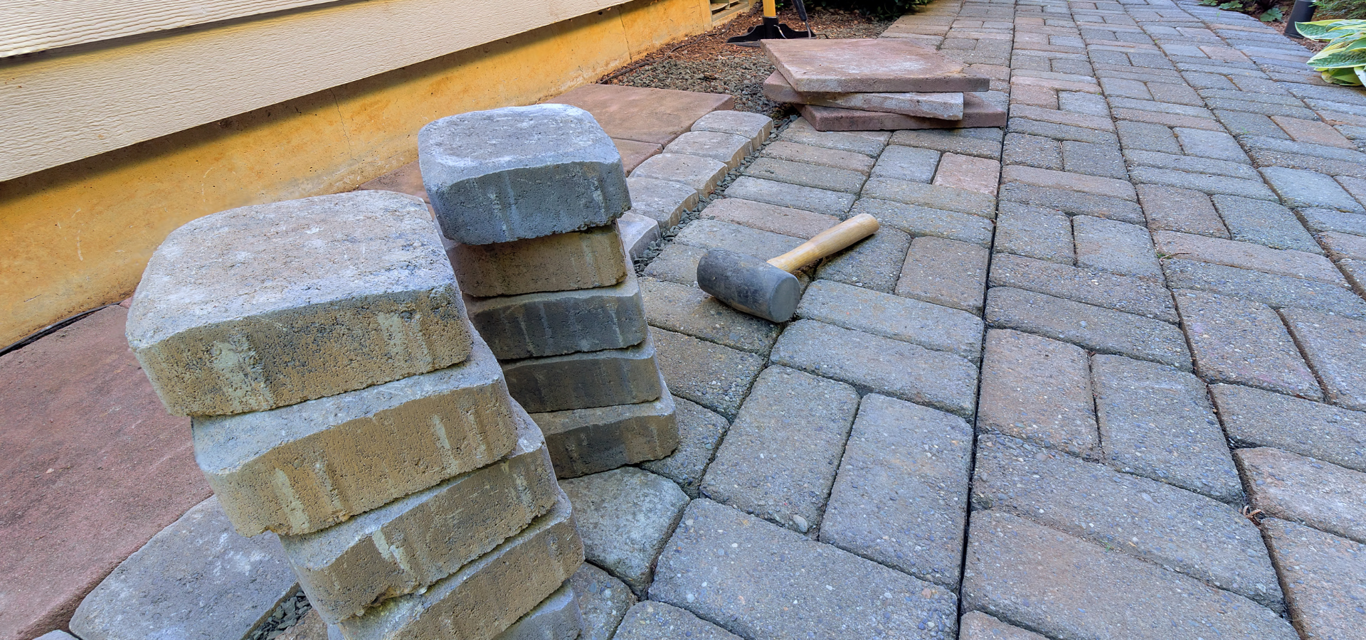 Louisville Landscape Pros installing stone pavers for our client's patio