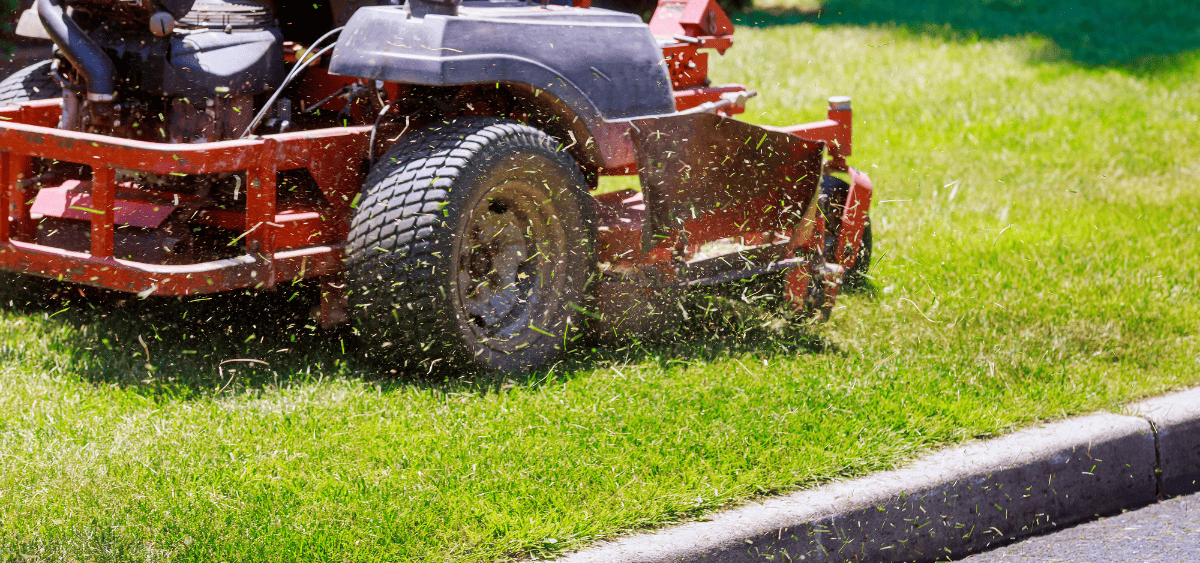 Landscaper mowing a lawn for a homeowner in Lousville